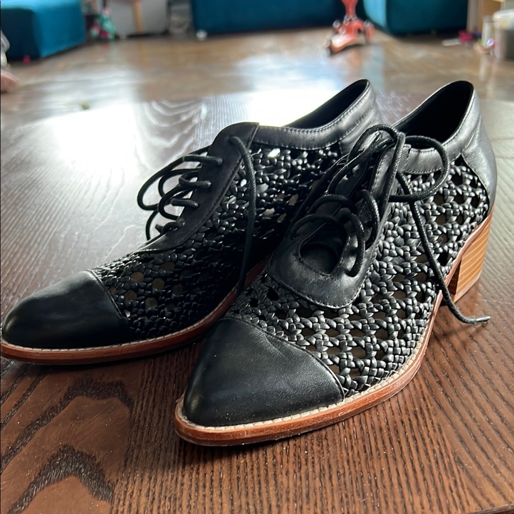 Black Heels with Intricate Pattern and Lace-Up Design